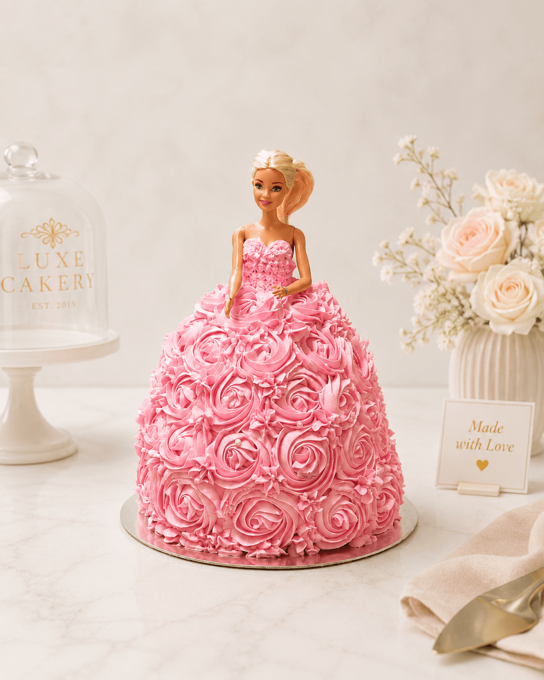 Doll cake with a sculpted pink buttercream rosette gown
