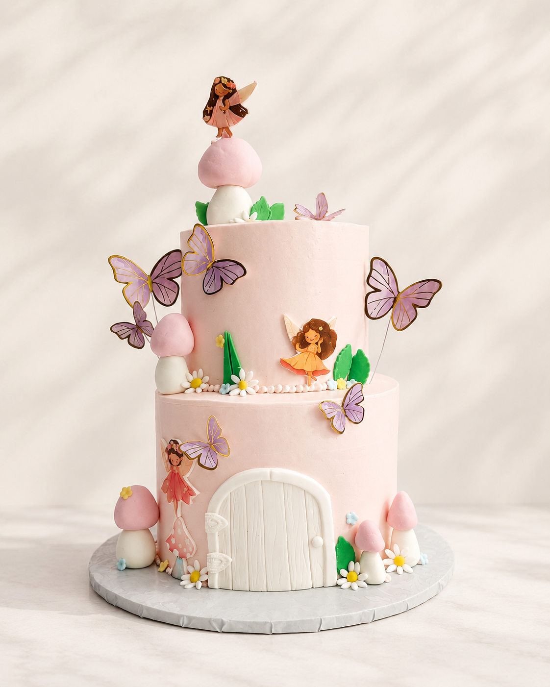 Whimsical two-tier fairy garden cake with sugar butterflies and hand-modeled details